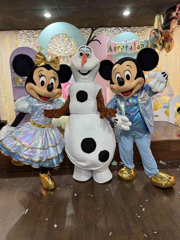Mickey, Minnie and Olaf characters at a kids party